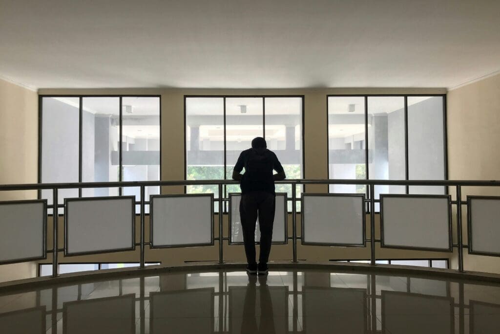 Man looking out from office gallery